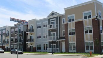 a row of new apartment buildings on a city street