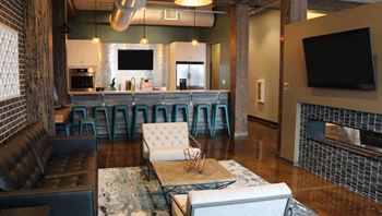 a living room with a couch and a bar and a television