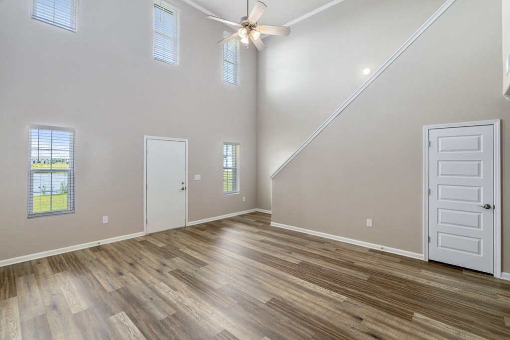 a living room with a vaulted ceiling and hardwood floors