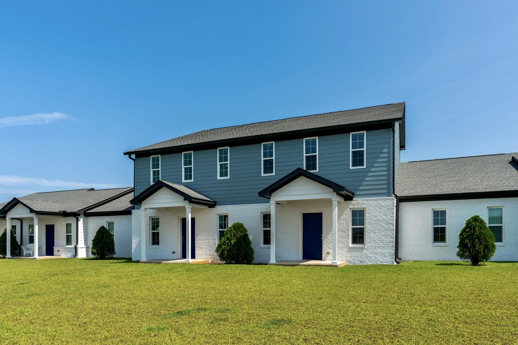a house with blue siding and a gray roof
