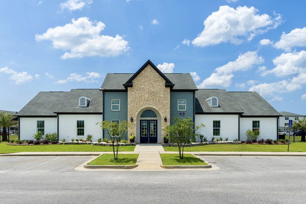 a house with a cloudy blue sky in the background