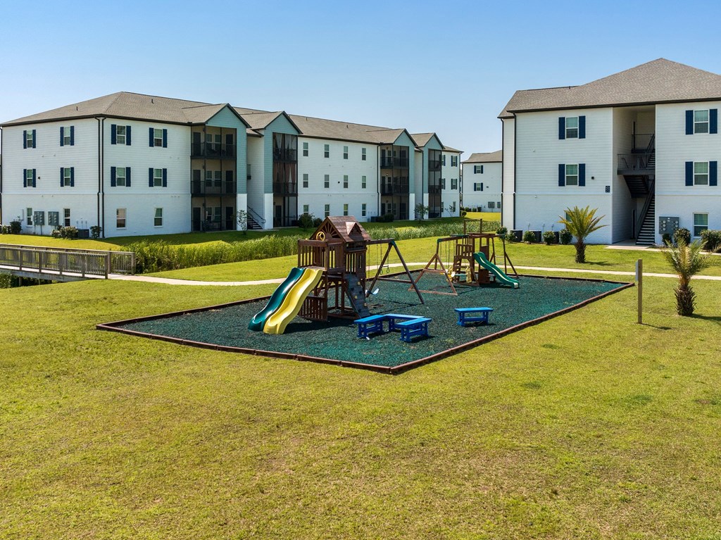 a playground at the enclave at woodbridge apartments in sugar land, tx