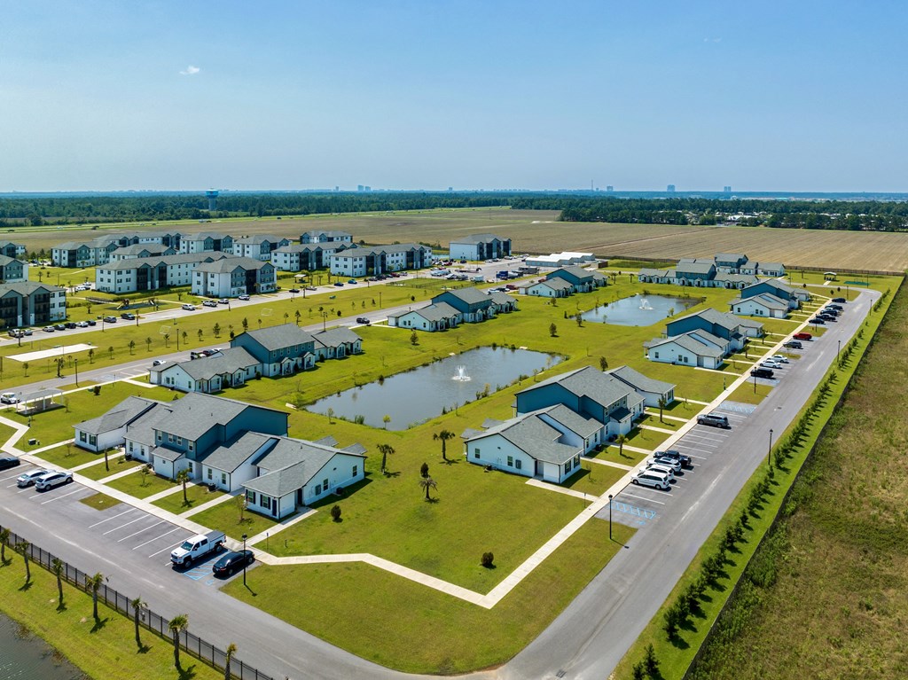 a row of houses on a grassy field