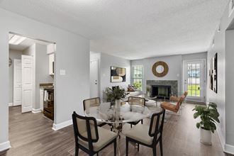 open living and dining area with fireplace  at Mirabelle Apartments in Mobile, Alabama