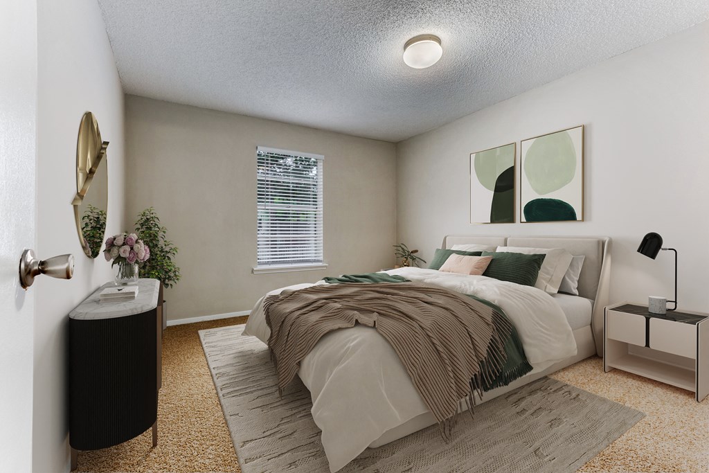 a bedroom with a bed and two paintings on the wall