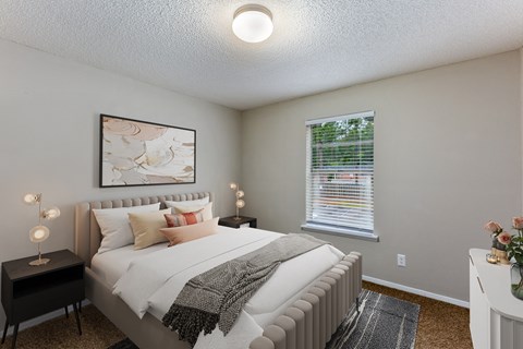 a bedroom with a large bed and two night stands with lamps on them