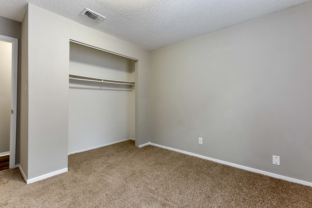 a bedroom with a closet and an open door