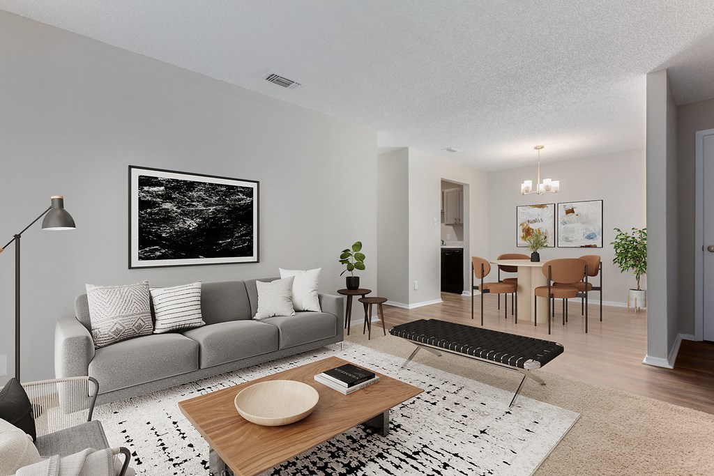 a living room with a gray couch and a wooden coffee table