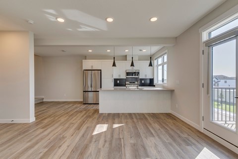 A spacious kitchen with wooden floors and a large island.