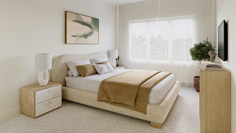 A bedroom with a large bed and a nightstand with a lamp.