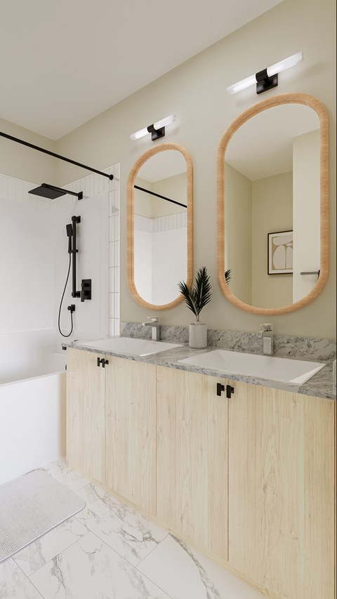 A bathroom with a marble countertop and wooden cabinets.