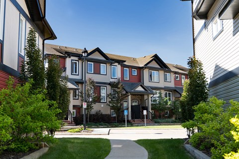 A row of houses with a clear blue sky above them.