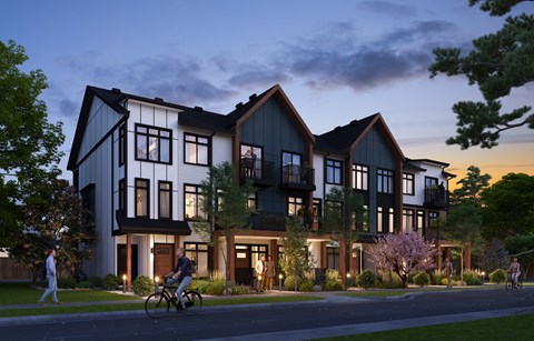 A modern house with a person riding a bicycle in front.