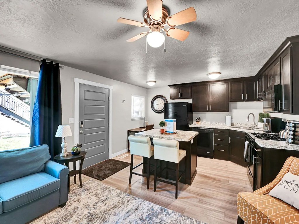 a living room and kitchen with a couch and a table