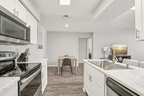 A modern kitchen with a dining table and chairs.