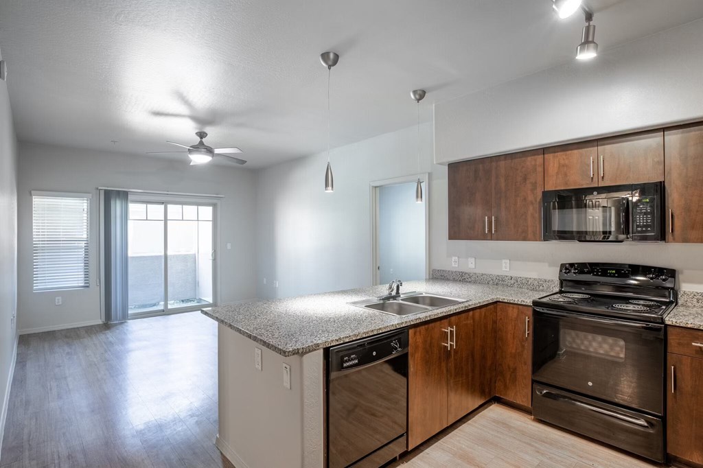 A kitchen with a stove, oven, and microwave.