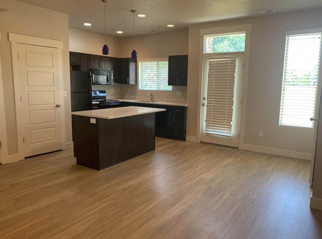 an empty kitchen with an island in the middle