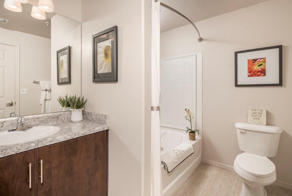 A bathroom with a white toilet and a white sink.
