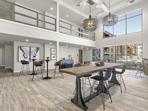 A modern dining room with a wooden table and chairs.