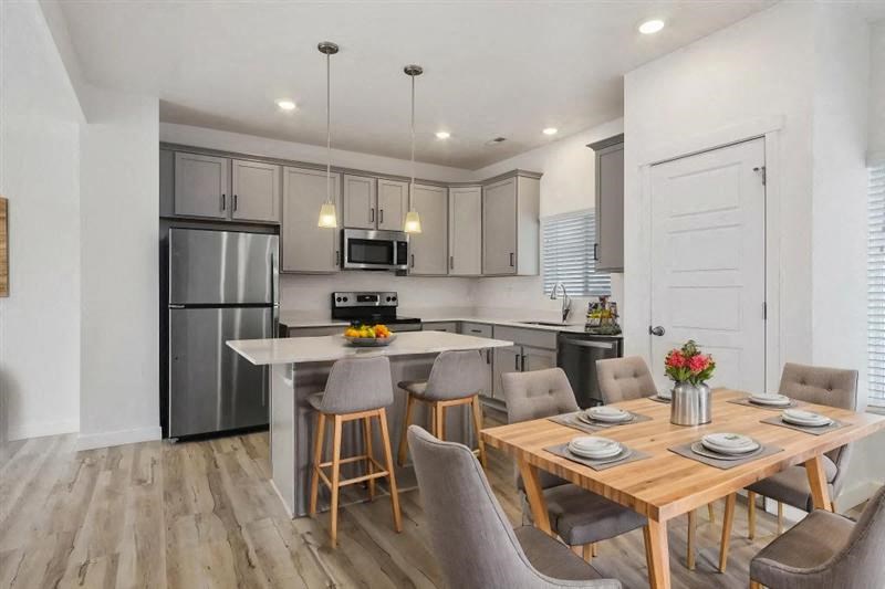 a kitchen and dining room with stainless steel appliances