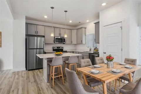a kitchen and dining room with a table and chairs