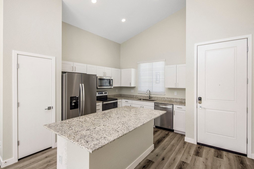 Linq at south mountain kitchen with white island and stainless steel appliances