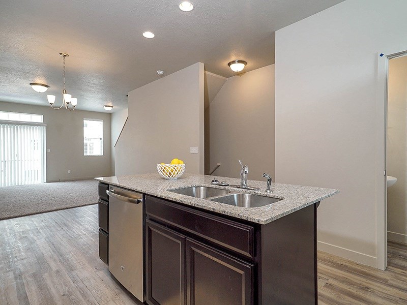 an empty kitchen with a sink and a counter top