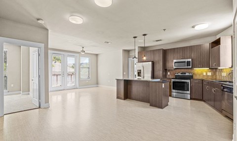 A spacious kitchen with wooden cabinets and stainless steel appliances.