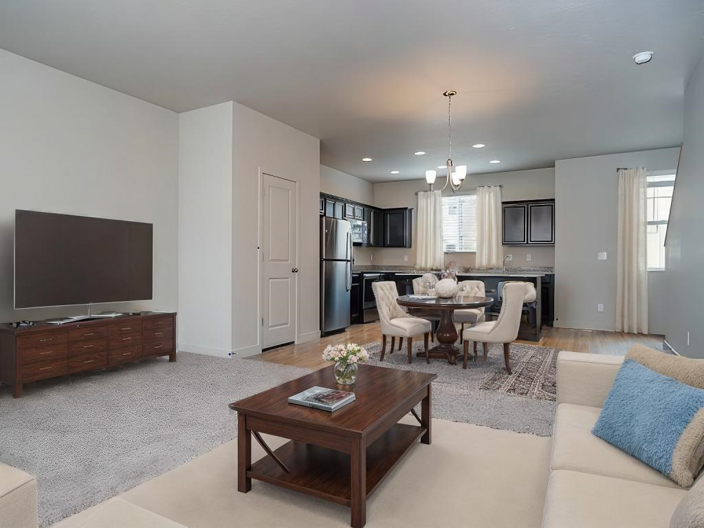A living room with a white couch and a wooden coffee table.