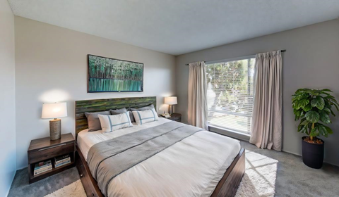 a bedroom with a large bed and a window