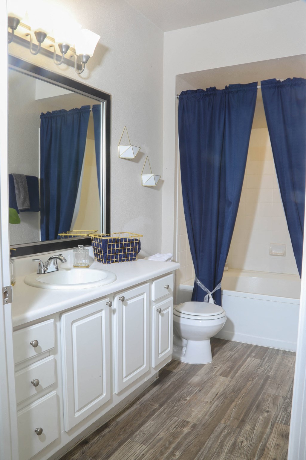 a bathroom with a toilet and a sink and a mirror at Sky at P83, Peoria, Arizona