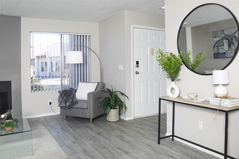 a living room with a couch and a mirror and a fireplace