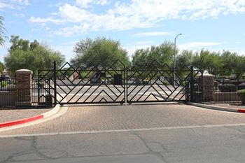 A black gate with a diamond pattern is closed.
