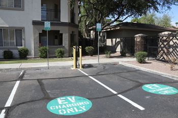 A parking lot with two spots designated for electric vehicles.