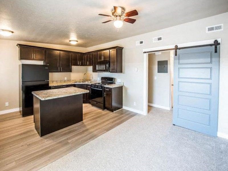 a kitchen with an island and a blue door