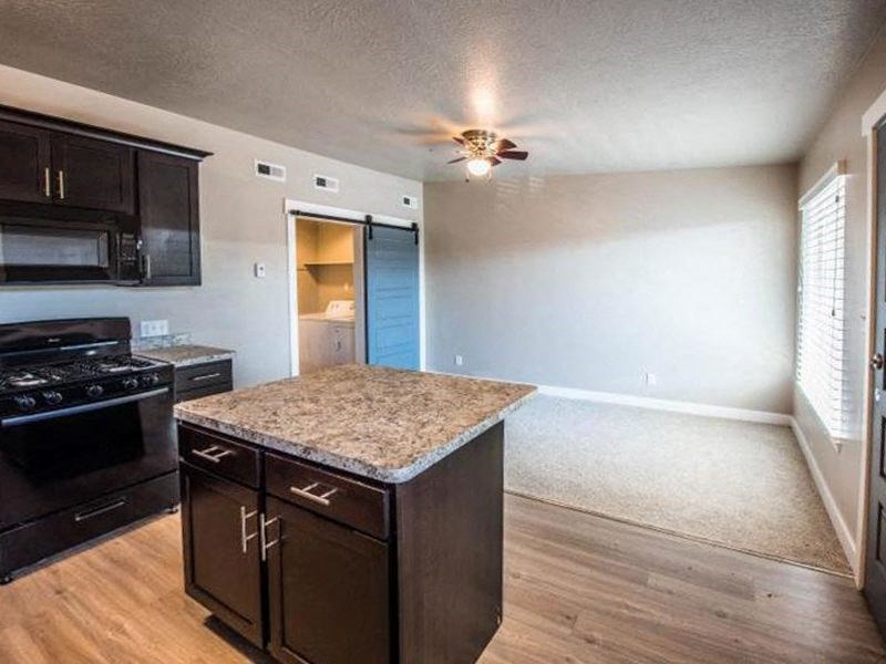 a kitchen with a granite counter top and a black stove
