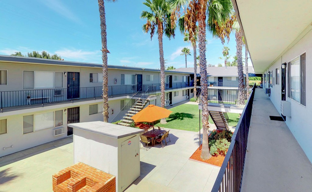 the courtyard of a hotel with palm trees