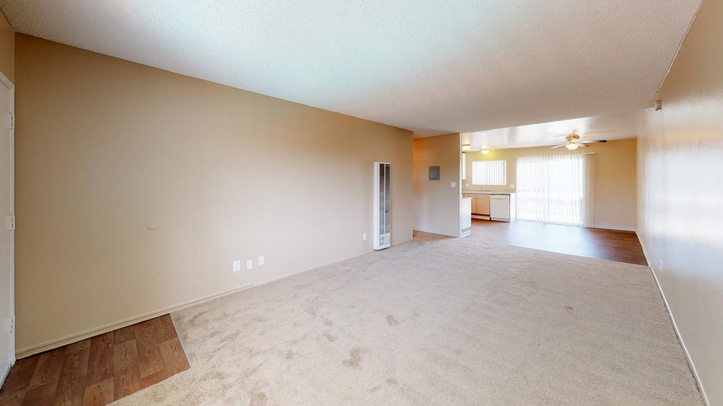 the living room and dining room of an empty house with a large floor plan
