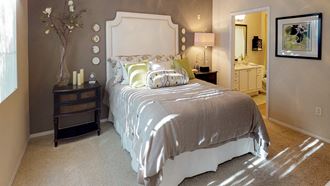 Master Bedroom Classically decorated bed with night stand and view of master bathroom at SKY at p83, Peoria, 85381