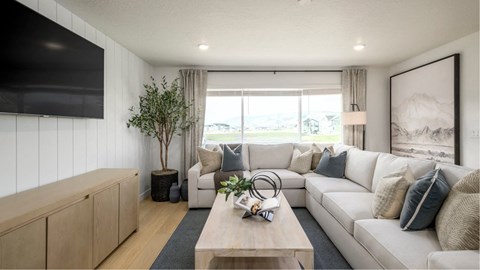 A modern living room with a large window and a white sofa.