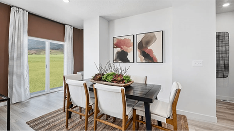 A dining room with a table set for four.