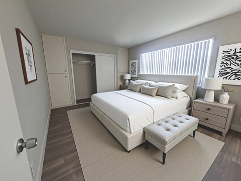 A bedroom with a large bed, a bench, and a dresser.
