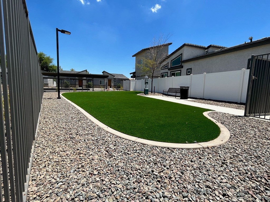 a yard with green grass in front of a building