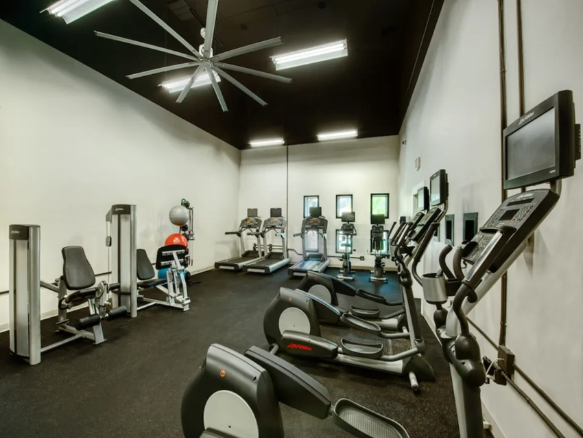 Enclave Fitness Center Fitness Center with Cardio Equipment, Overhead Ceiling Fan, and Windows on the Far Wall at Enclave at Paradise Valley, Phoenix, AZ - Photo Gallery