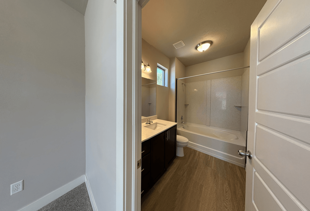 an empty bathroom with a shower toilet and sink