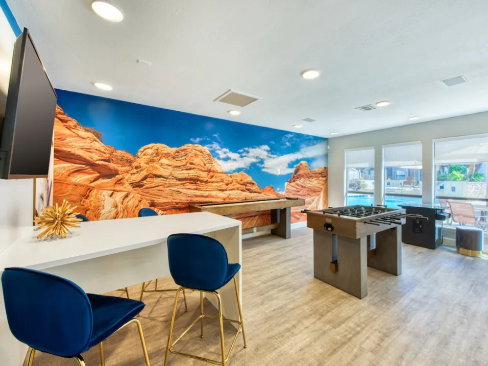 Clubhouse and Game Room with Plank Flooring and Large Windows Looking out to the Pool at Enclave at Paradise Valley, Arizona