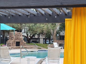 Poolside Relaxing Chairs with Tangerine Colored Curtains for Shade at Sky at P83, Peoria, 85381