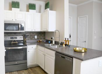 a kitchen with white cabinets and stainless steel appliances at Sky at P83, Peoria, AZ, 85381