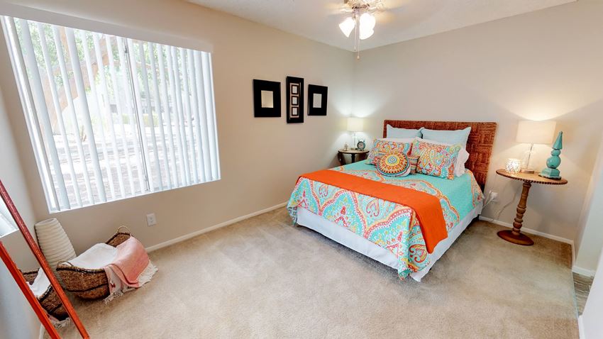 a bedroom with a bed and a large window