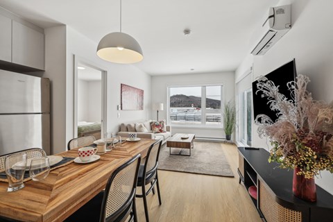 A modern dining room with a wooden table and chairs.